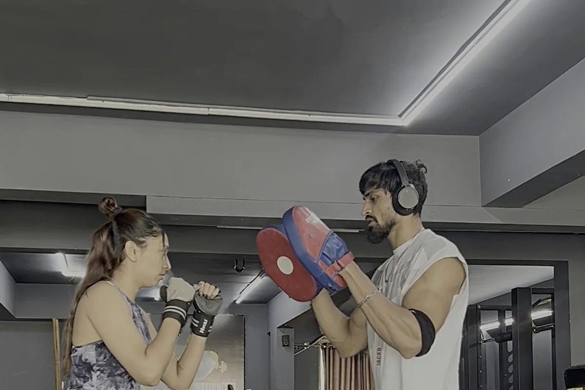 Coach Meet coaching a client through pad work in Vadodara